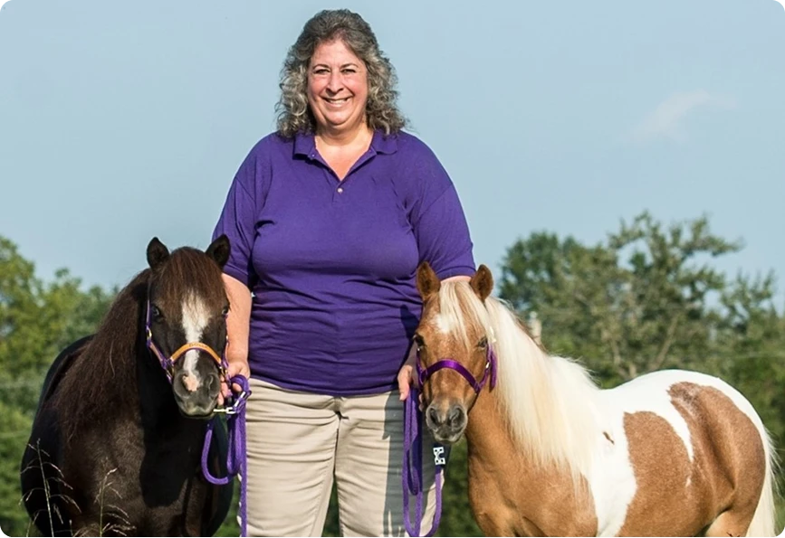Cheryl handling two miniature horses