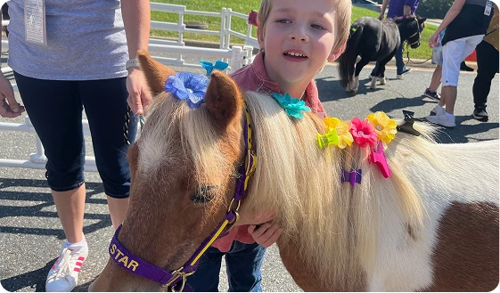 Child with Mini Horse at Event