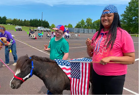 Mini horse with child at Post High Program